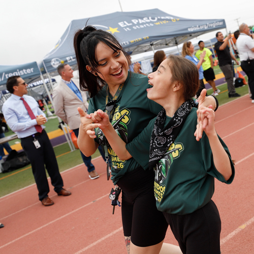 Participants of the Unidos Games race on the track