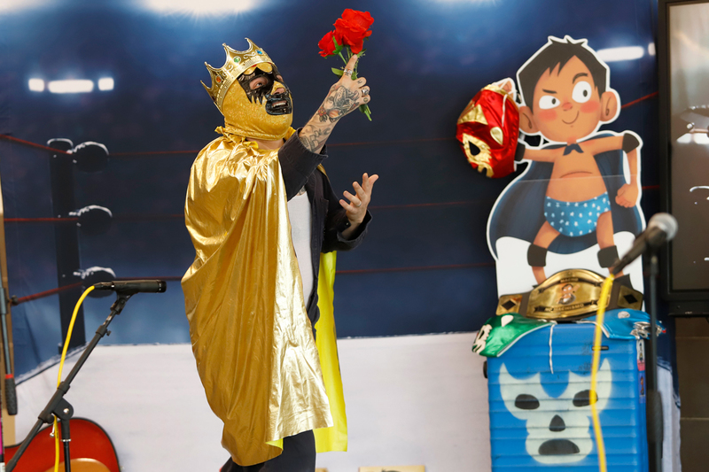 a luchador poses at LitFest
