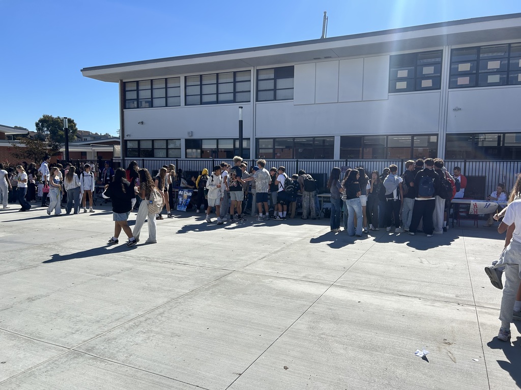 Students gather outdoors in a large school courtyard