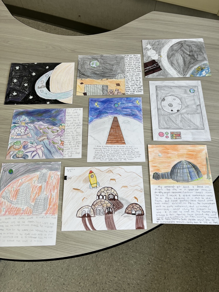Collection of colorful hand-drawn space-themed illustrations with handwritten notes on a wooden table.