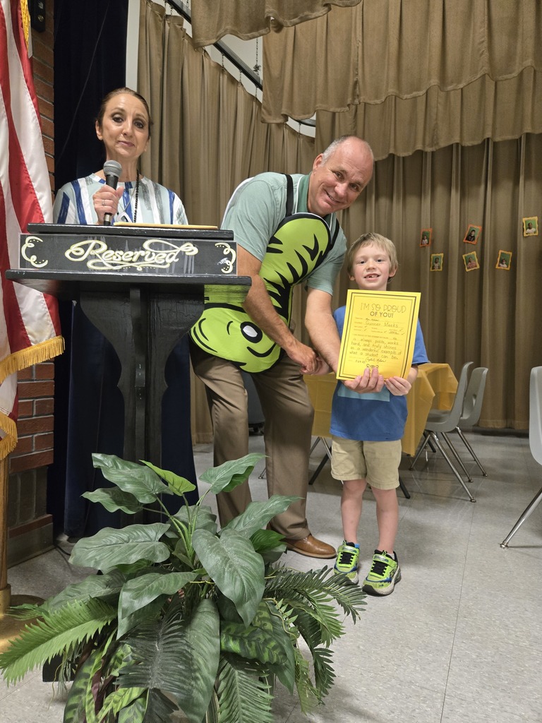 A student holding a certificate.