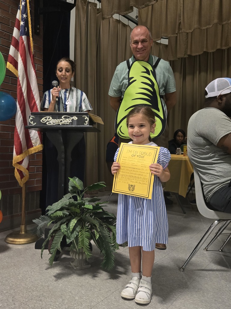 A student holding a certificate.