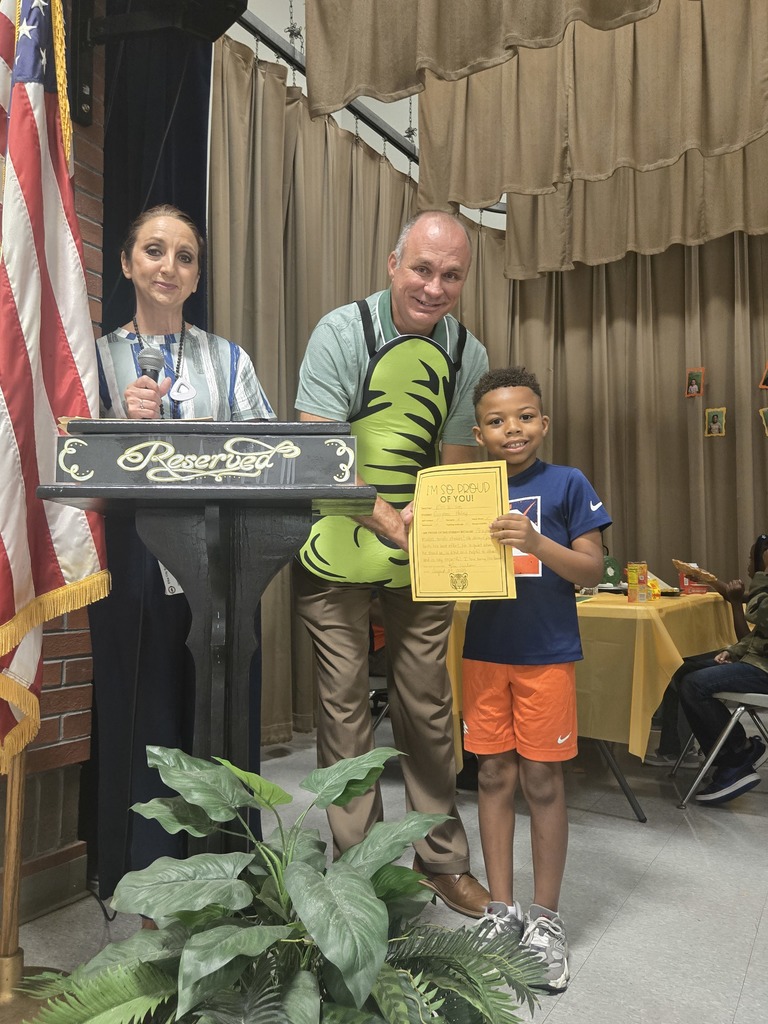 A student holding a certificate.