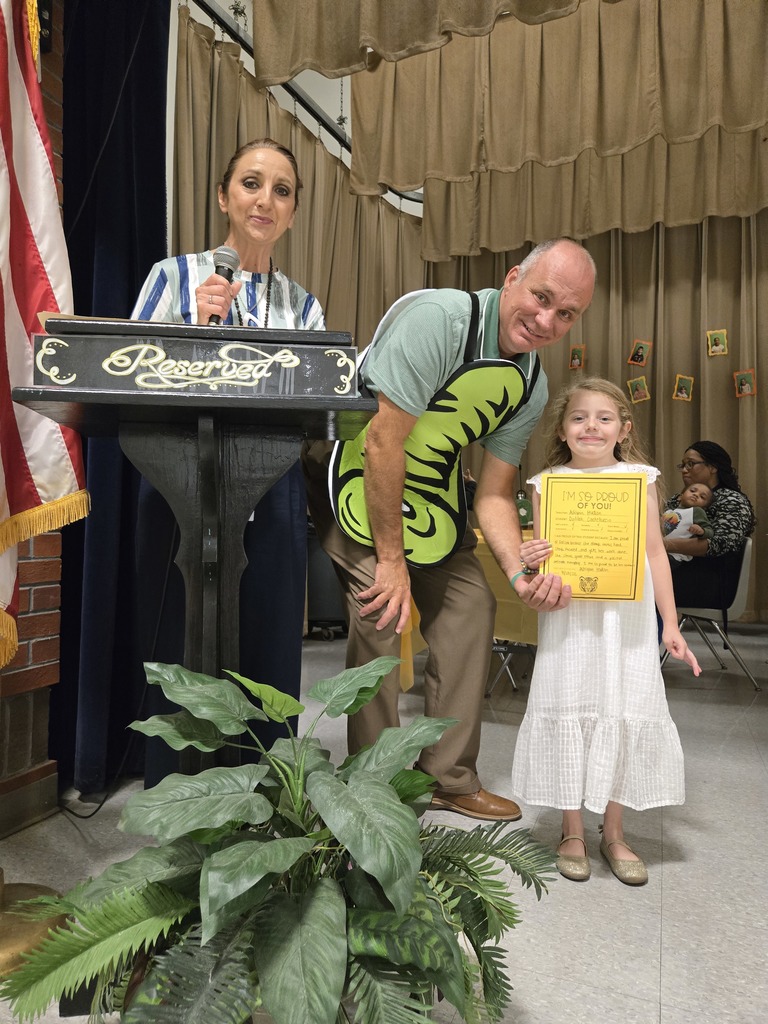 A student holding a certificate.