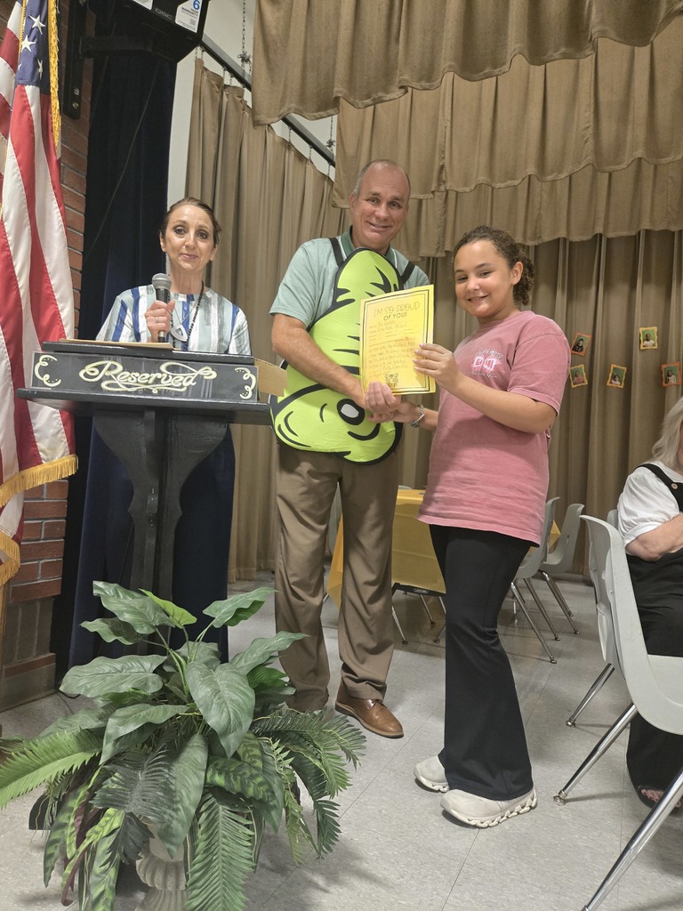A student holding a certificate.