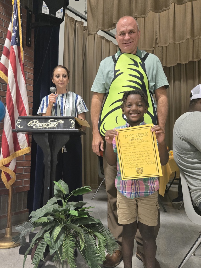A student holding a certificate.