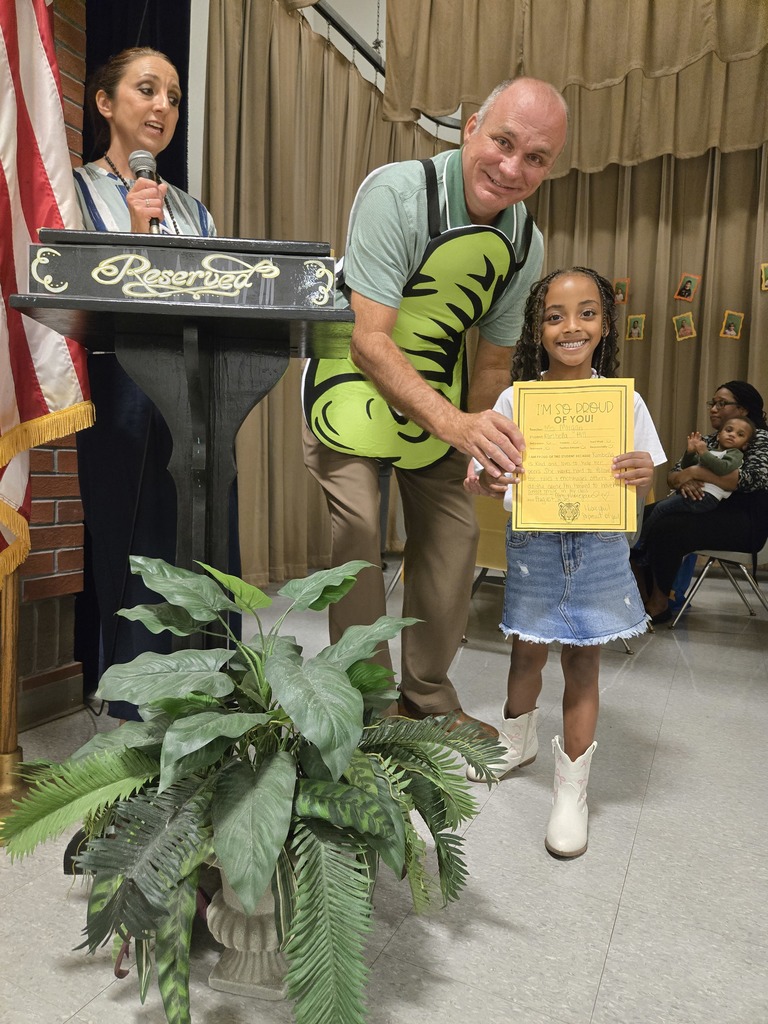 A student holding a certificate.
