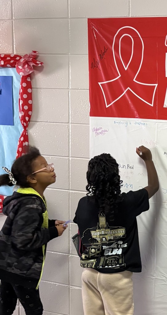 Students signing a red ribbon week pledge.
