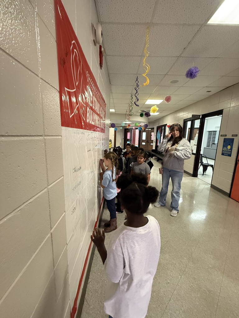 A group of kids in a hallway.