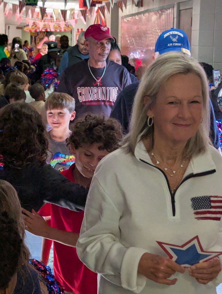 A group of people walking down a hallway.