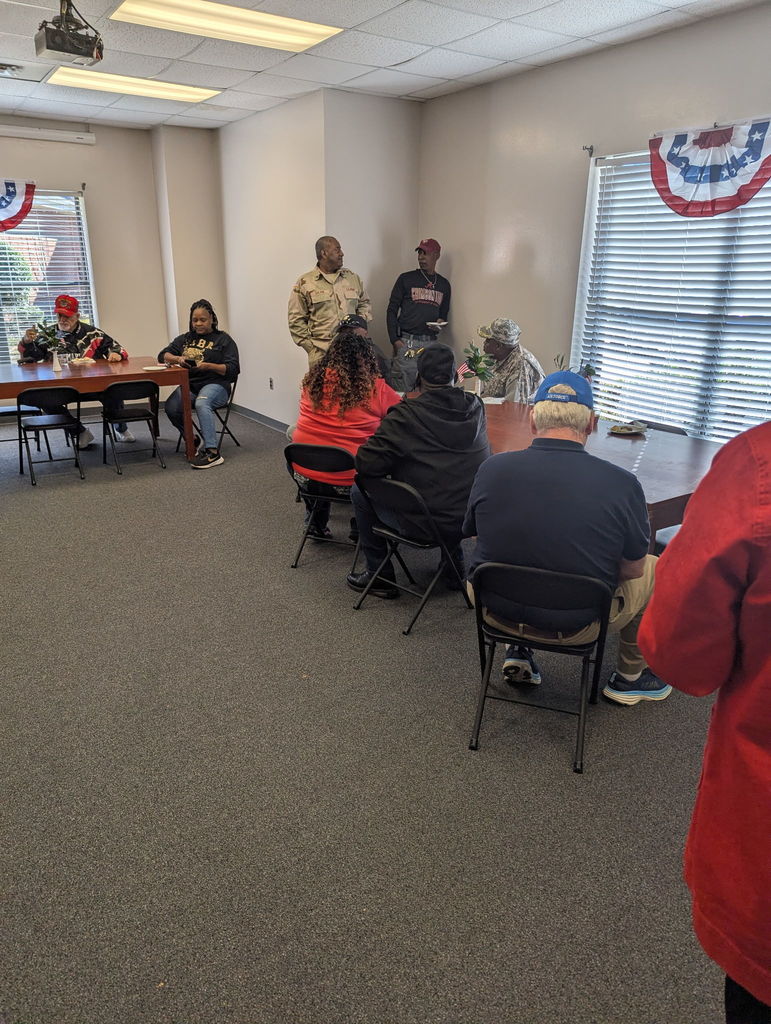 A group of people walking down a hallway.