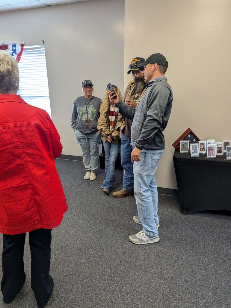 A group of people walking down a hallway.
