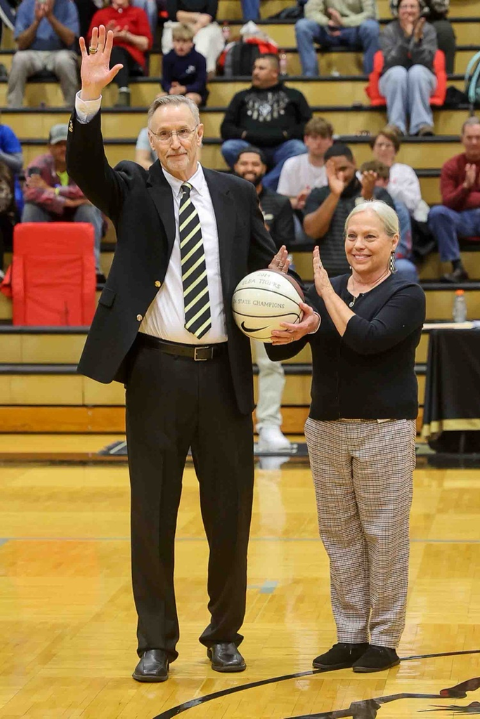 Two people standing on a basketball court.