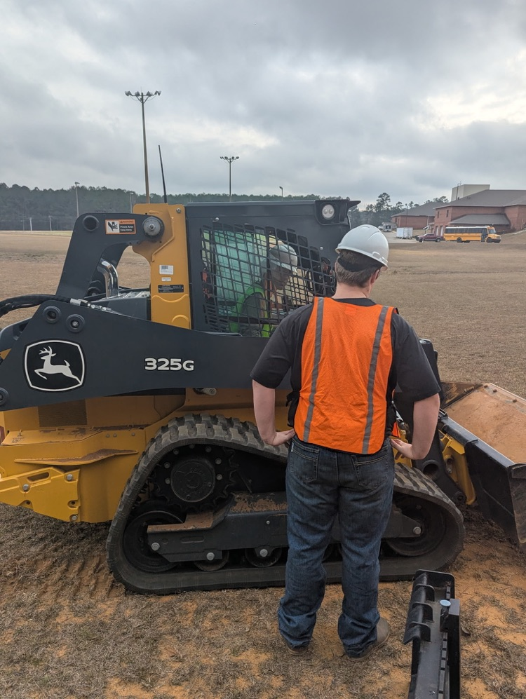Kids operating a piece of machinery.