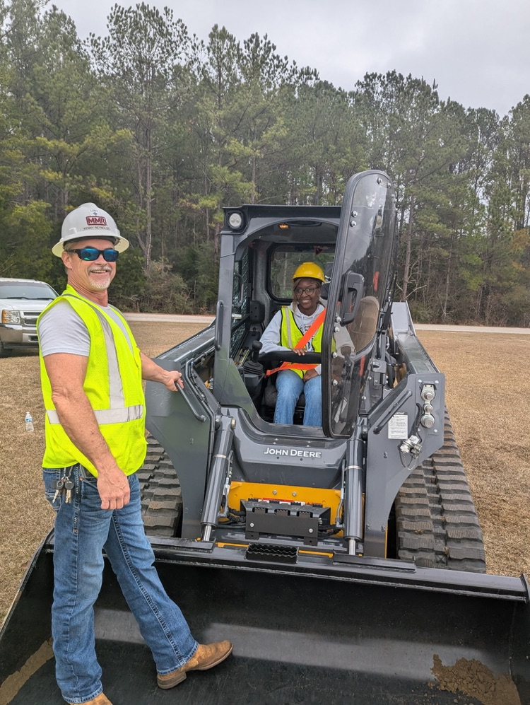 Kids operating a piece of machinery.