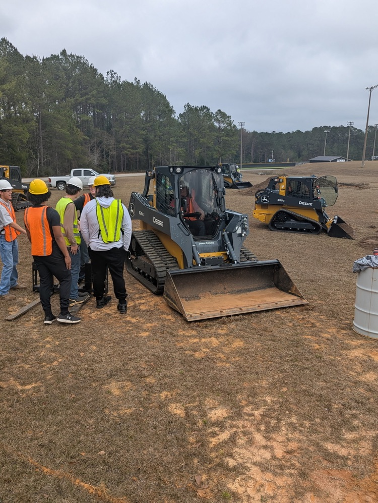 Kids operating a piece of machinery.