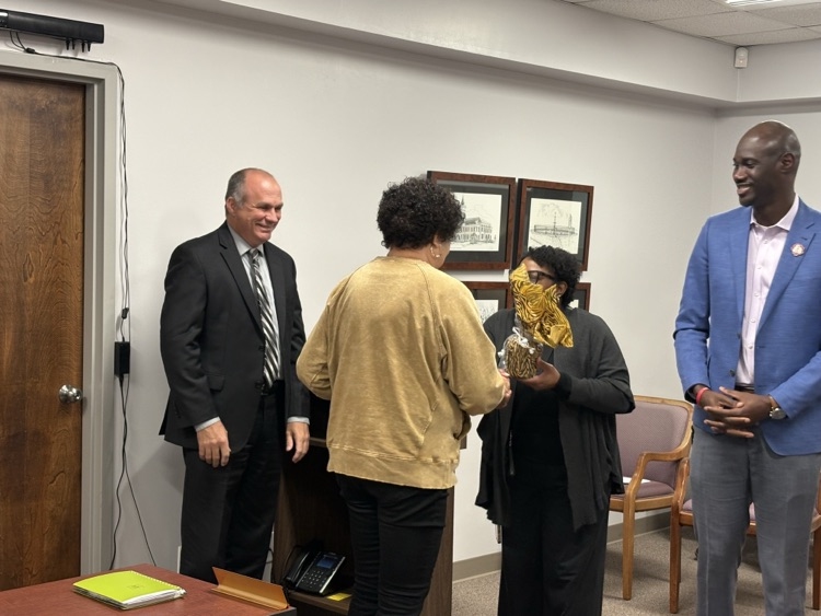 A group of people giving a gift.