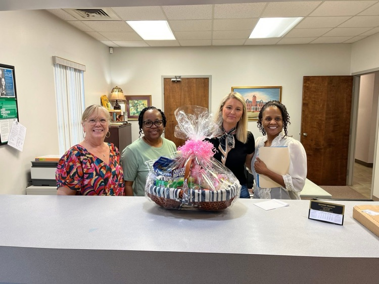 A group of ladies posing for a picture .