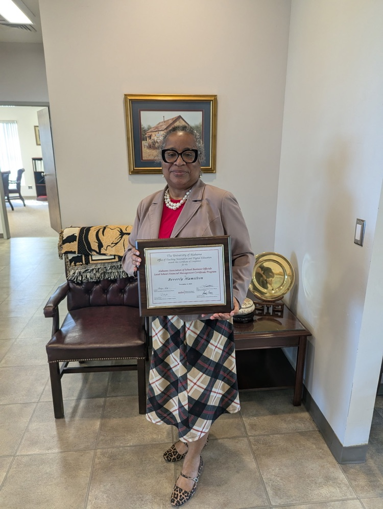 A woman holding a plaque.