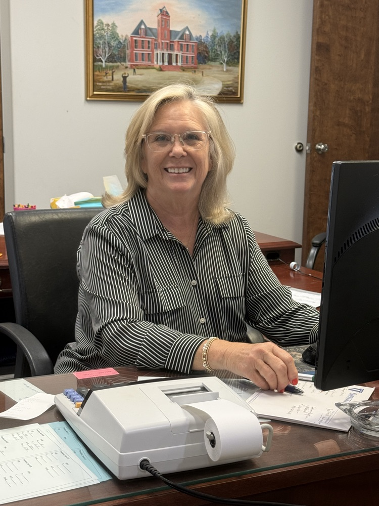 A woman sitting at a desk.