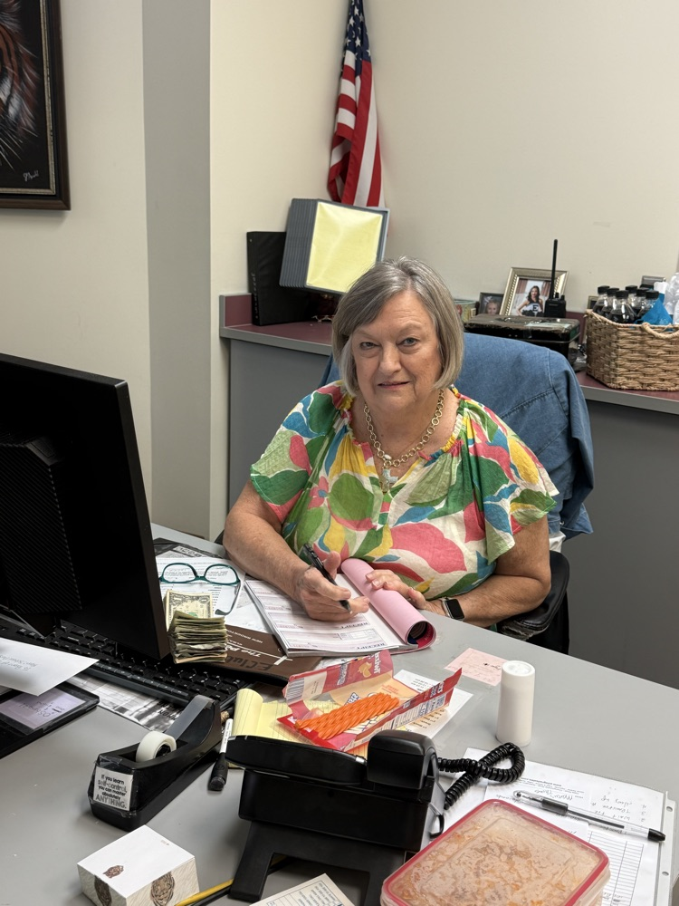 A woman sitting at a desk.