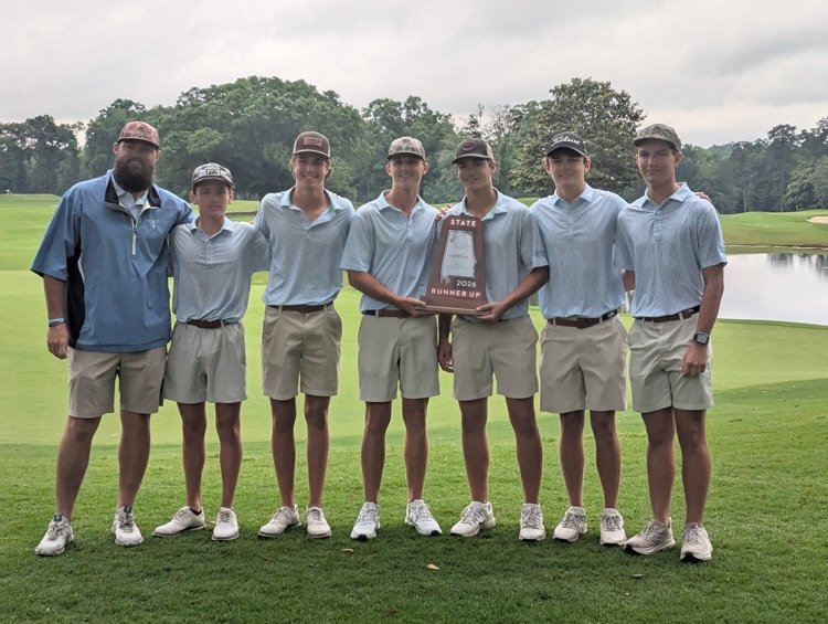 A group of guys holding a trophy!