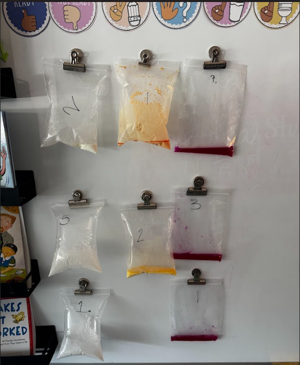 image of zip lock bags with solutions in them hanging up by magnet clips