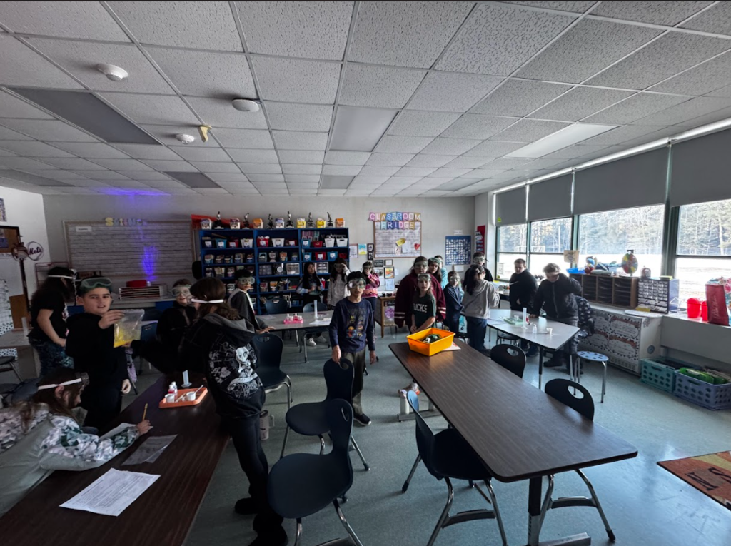 Image of a classroom with students performing science experiments