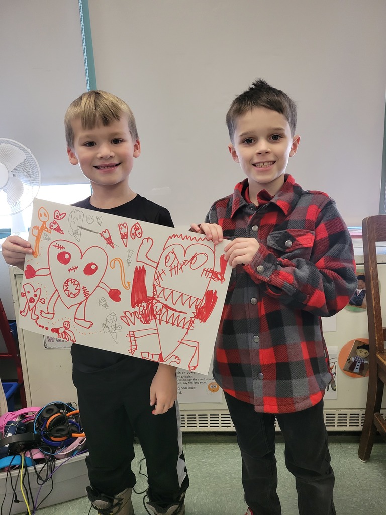 Image of students holding up the Partner drawing they made in friendship club