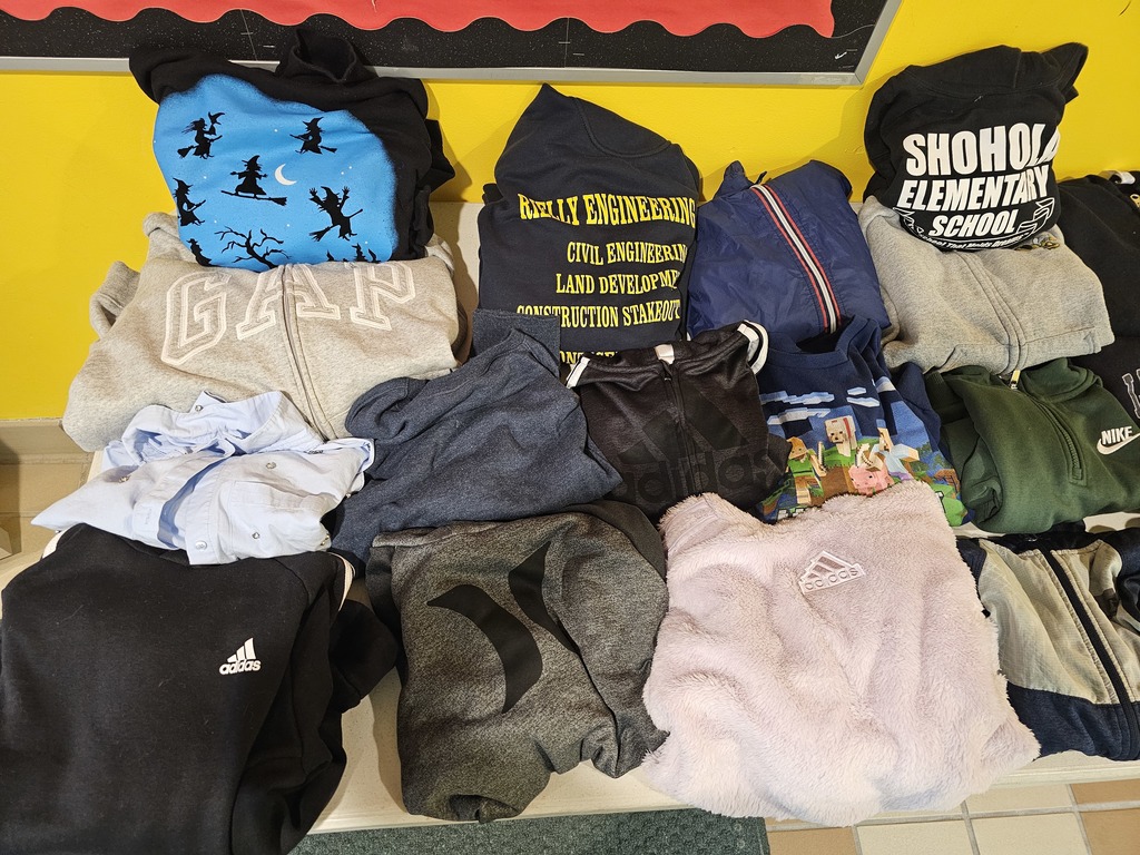 Image of a lot of sweatshirts in lost and found waiting to be claimed