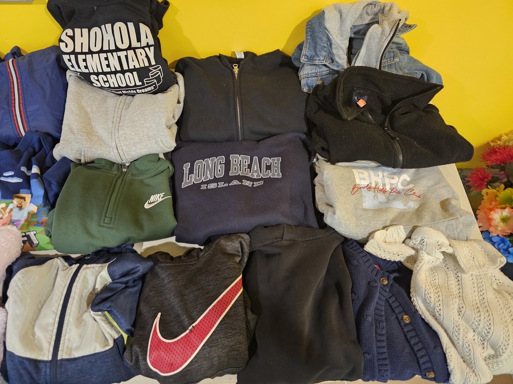 Image of a lot of sweatshirts in lost and found waiting to be claimed