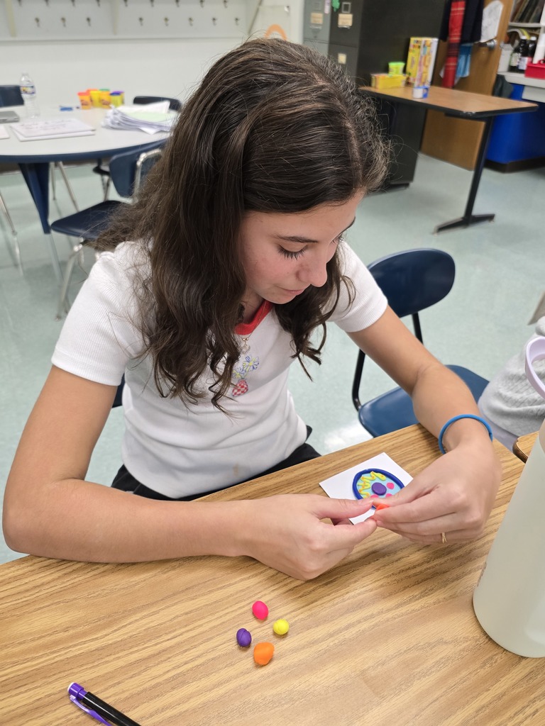A student in 6th grade science class makes a model of an animal cell out of playdoh