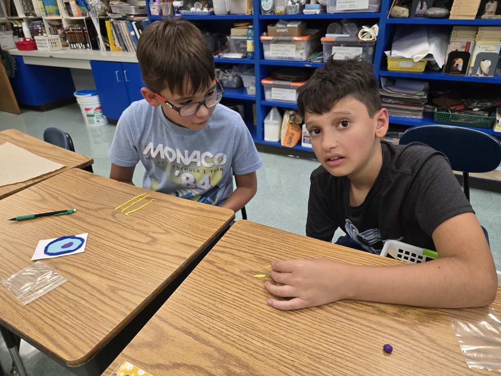 students in 6th grade science class making a model of an animal cell out of playdoh