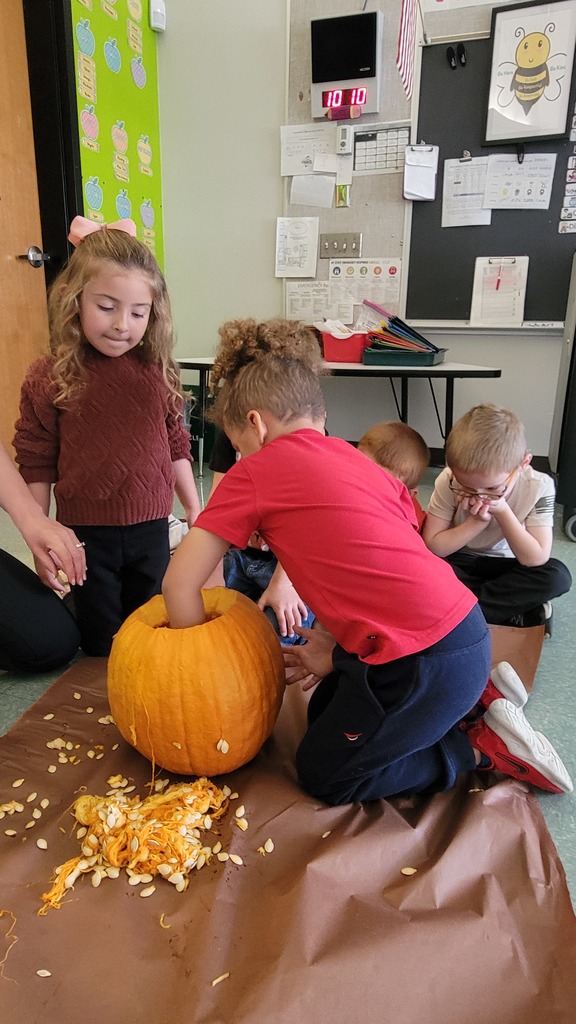 Image of students carving a pumpkin