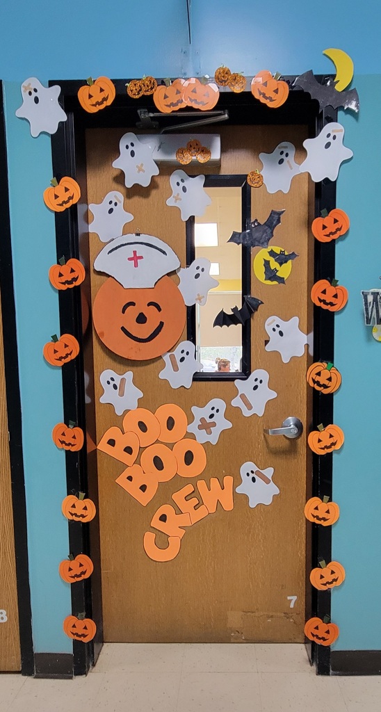 The school nurse's door decorated with bats, jack-o-lanterns and bats that reads "Boo Boo Crew"