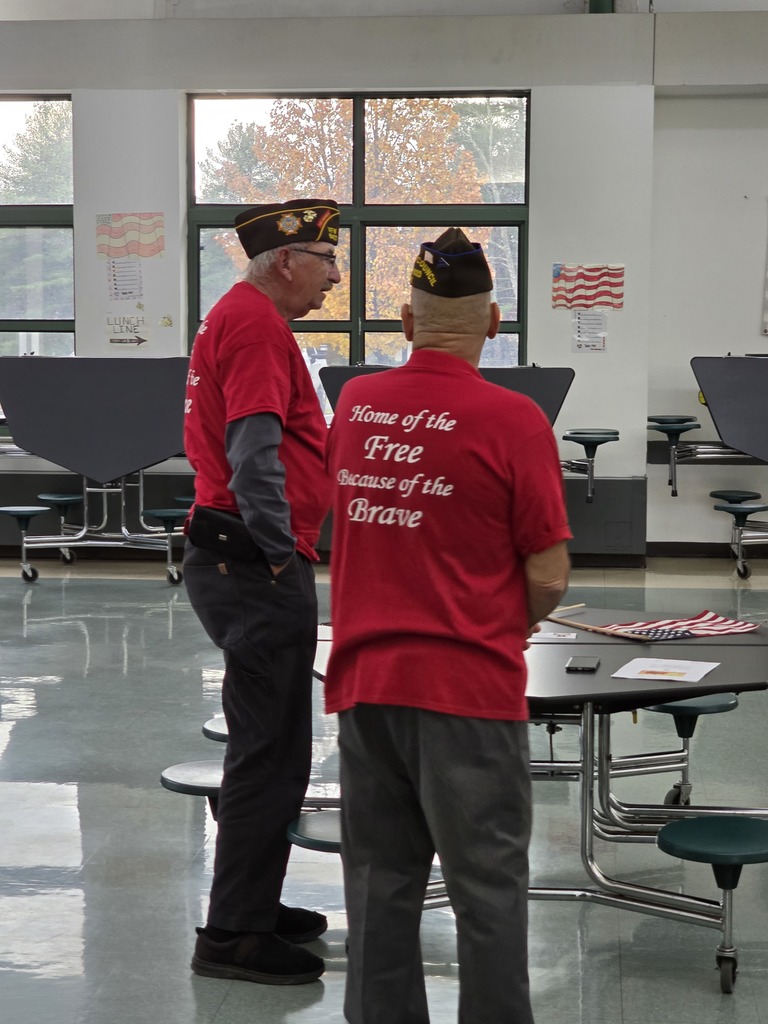 Image of a veteran with his back to the camera wearing a shirt that says "Home of the Free because of the Brave"