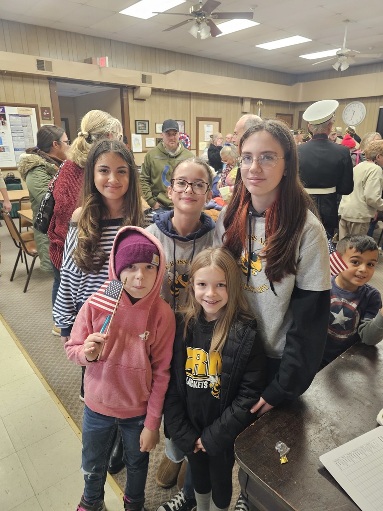 A group of students with hand-held American Flags pose for the camera