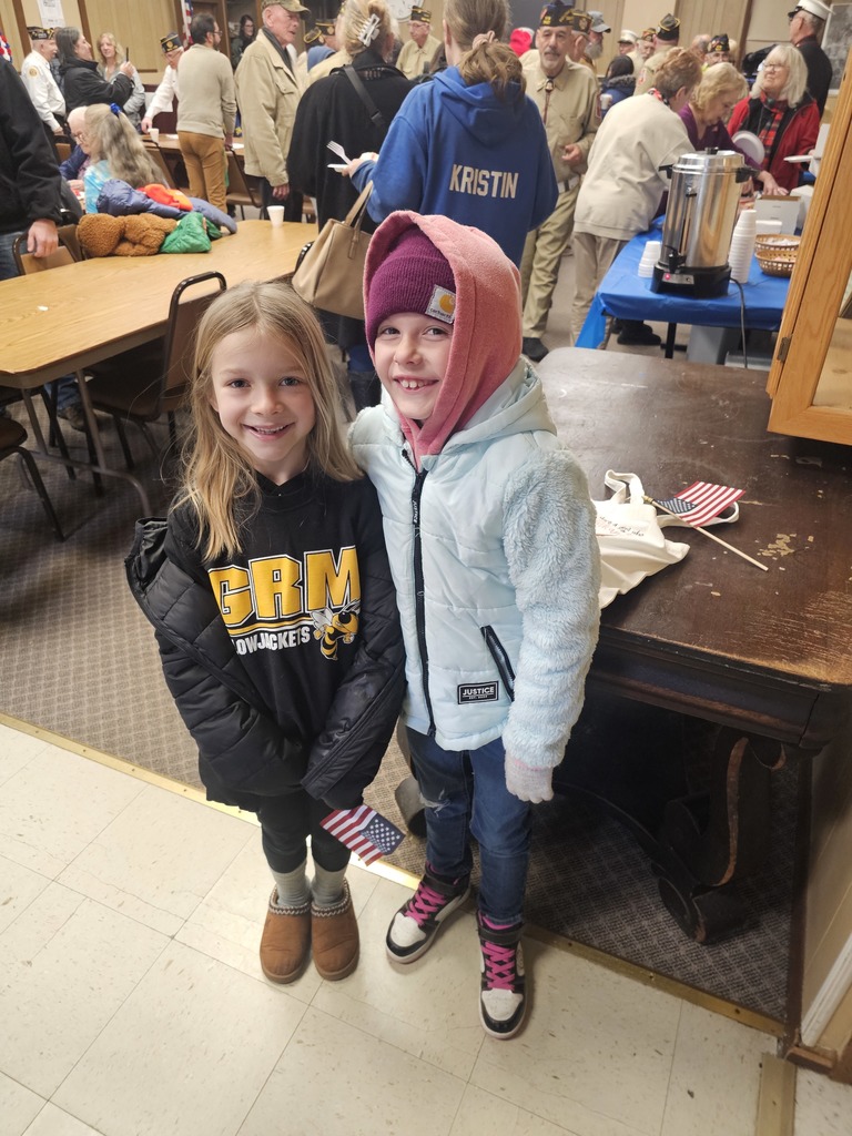 Two students pose for the camera at a Veterans Day event