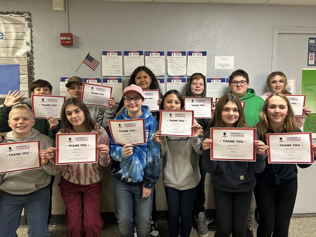 7th graders holding their certificates
