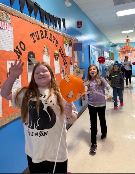 Image of students walking in their balloon parade