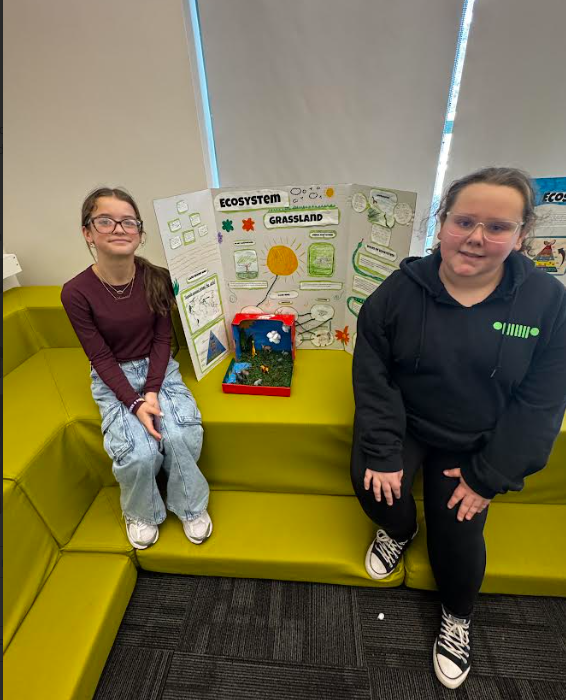 Image of students posing with their ecosystems project