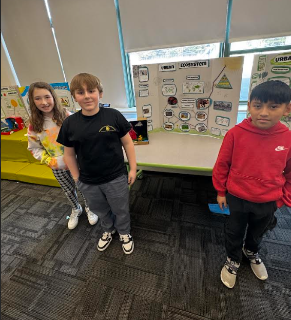 Image of students posing with their ecosystems project