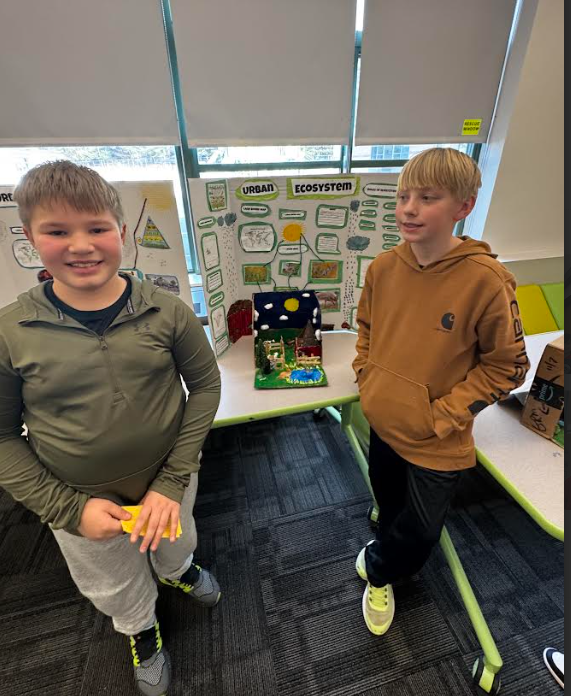 Image of students posing with their ecosystems project