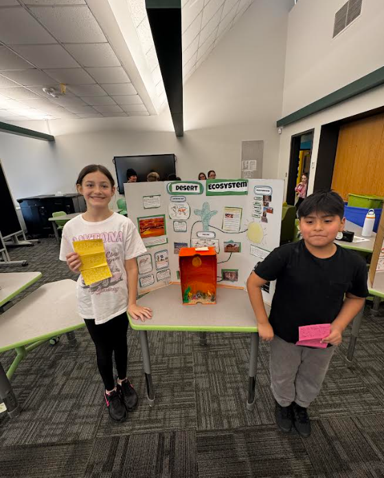 Image of students posing with their ecosystems project