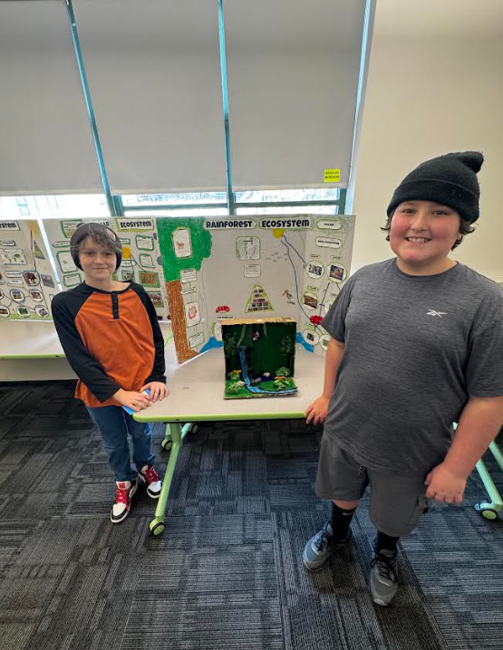 Image of students posing with their ecosystems project