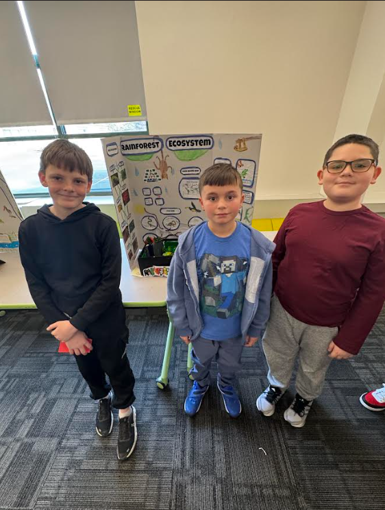 Image of students posing with their ecosystems project