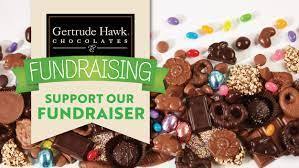 Image of various chocolates and candies with the Gertrude Hawk Chocolates Fundraising logo