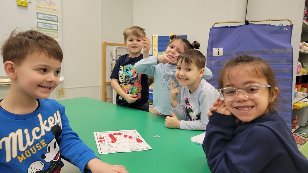 Students pose for the camera while playing a winter themed literacy games