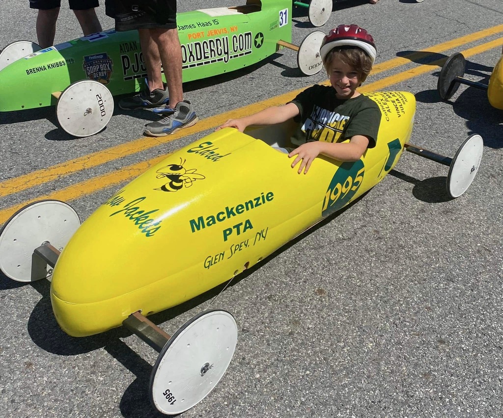 Image of a student in the GRM PTA's Soap Box Derby Car