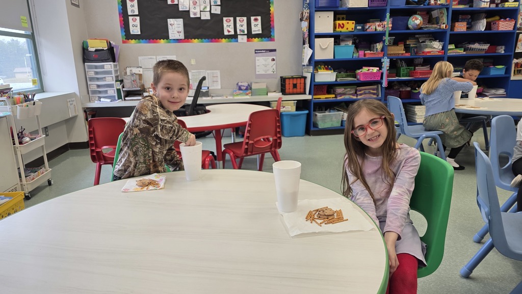 Image of students enjoying snacks in the classroom during their hot chocolate party that they earned for positive behavior choices.